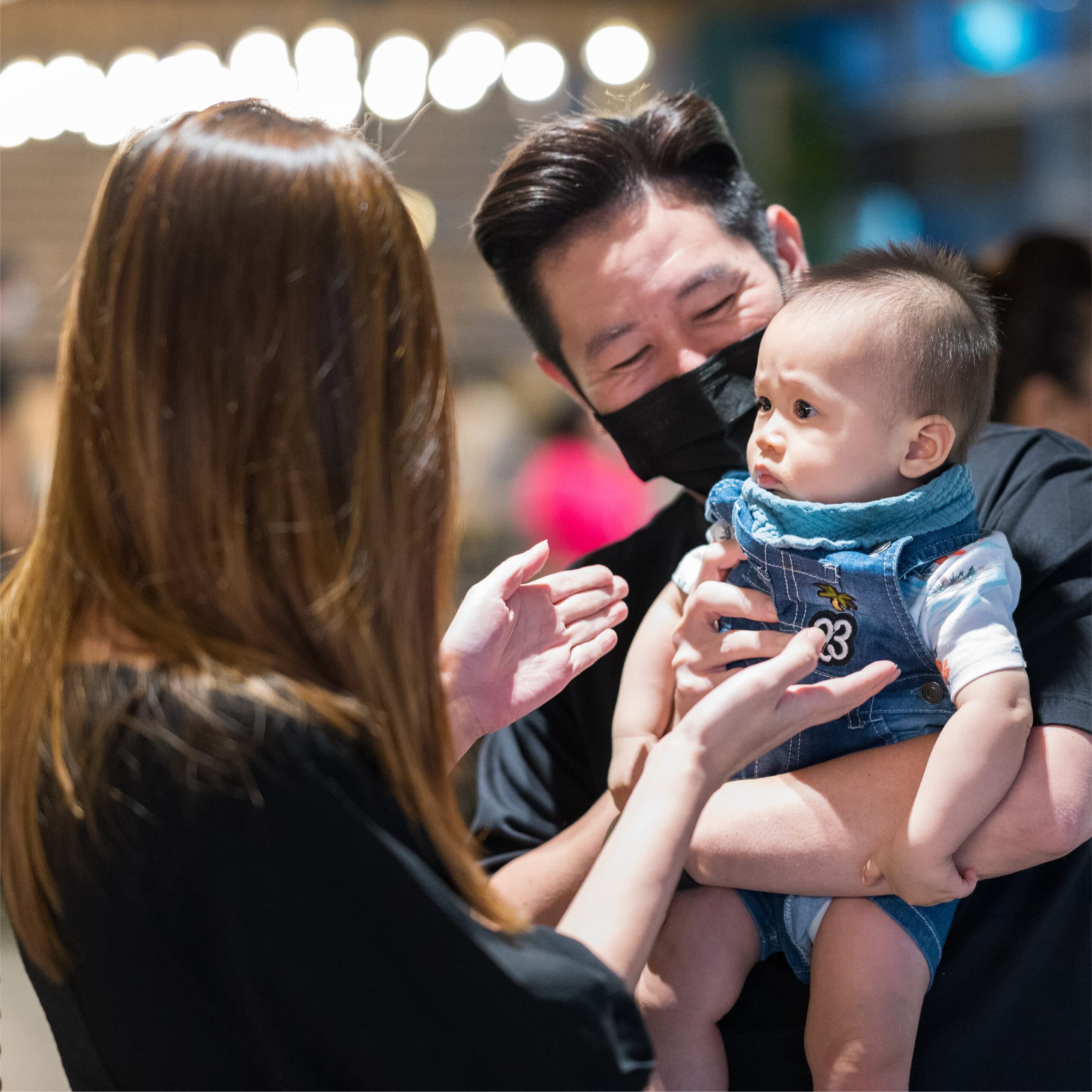 A family with their baby at a restaurant celebration.