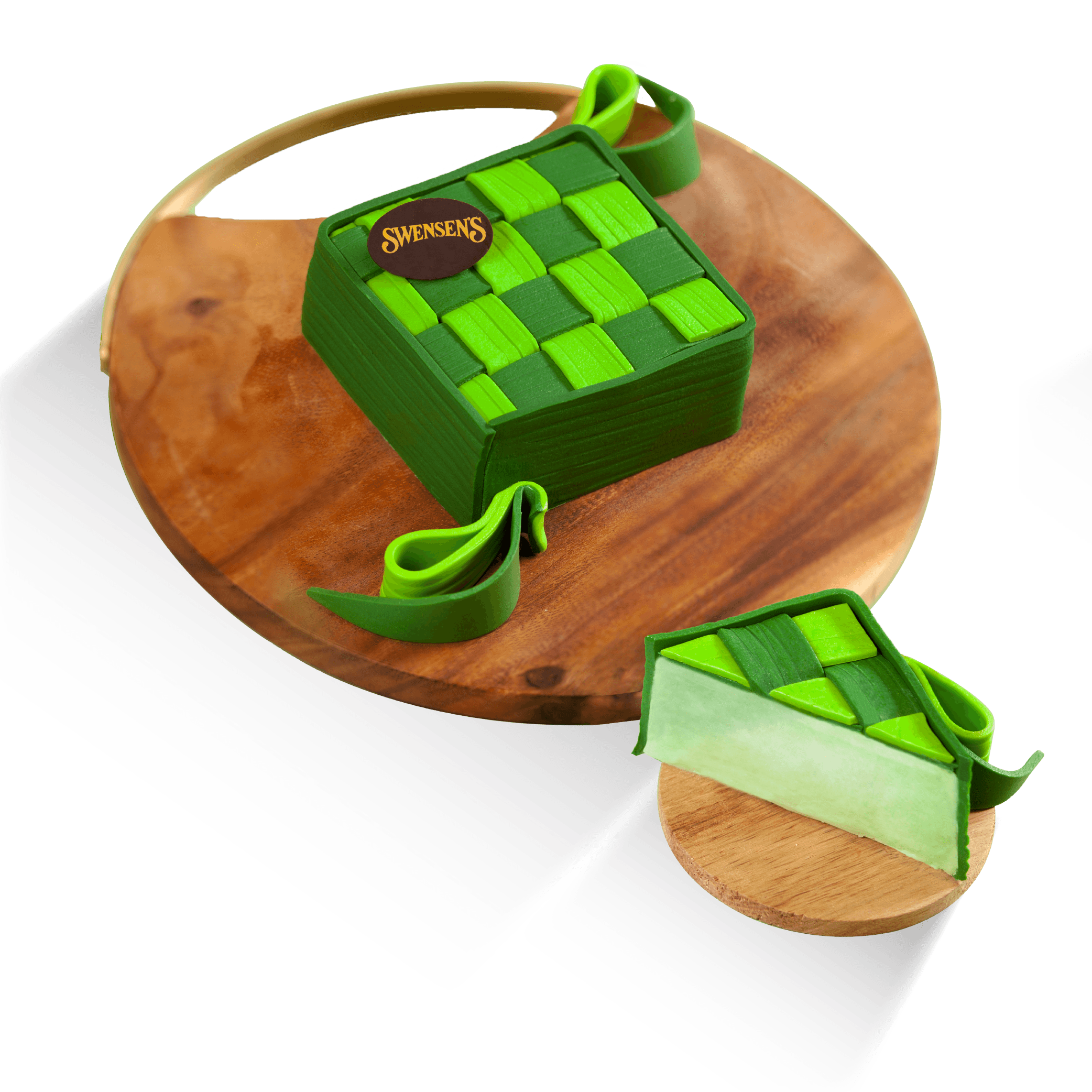 Green woven ketupat-shaped ice cream cake, with a slice showing its centre.