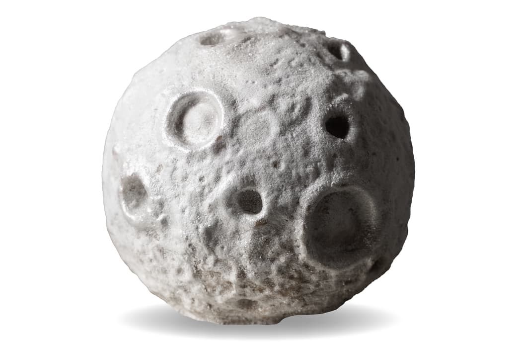 Silver Micro Moon ice cream cake with a cratered surface.
