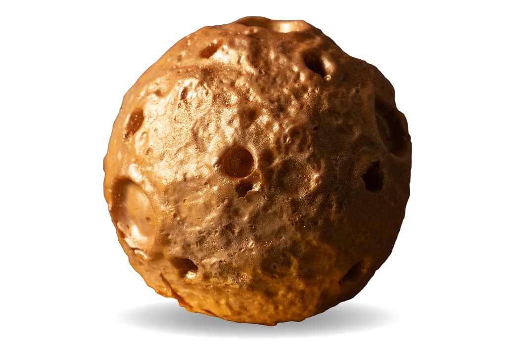 Gold Super Moon ice cream cake with a cratered surface.