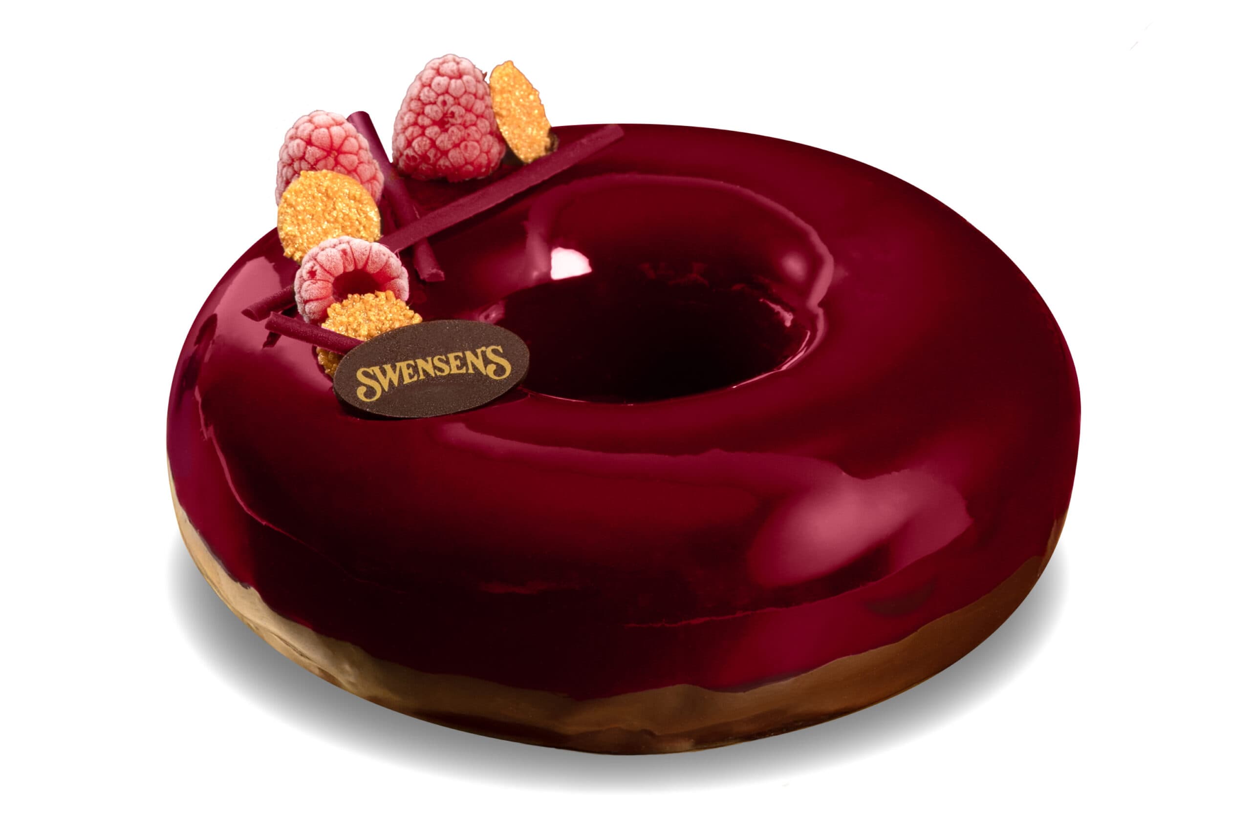 Halo Christmas ring-shaped cake with a glossy red glaze and raspberry decorations