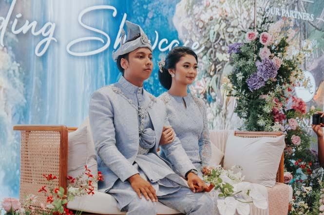 A couple celebrating at The Acacia’s floral wedding setting